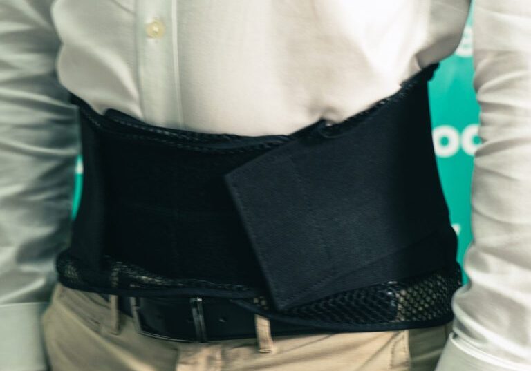 A young man in jeans and a t-shirt wearing the betbak back brace