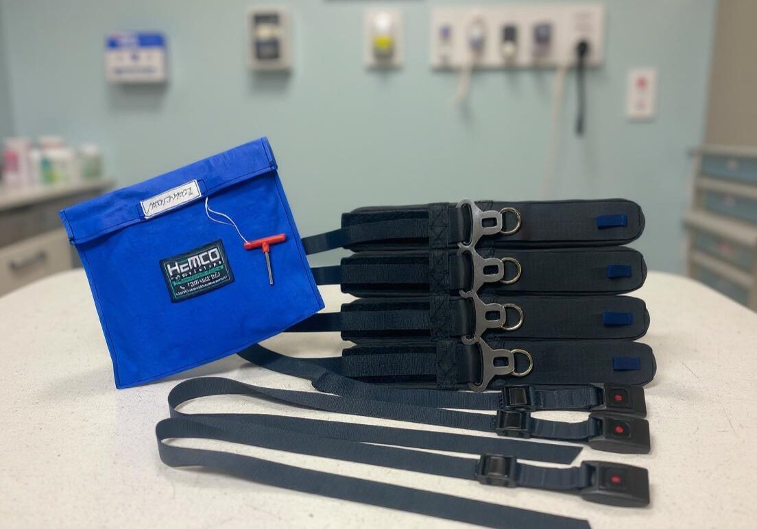 A modified patient restraint set on a hospital bed